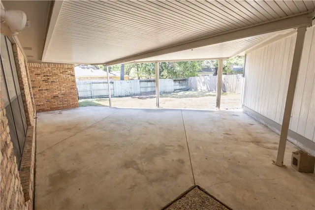 a view of an empty room with windows