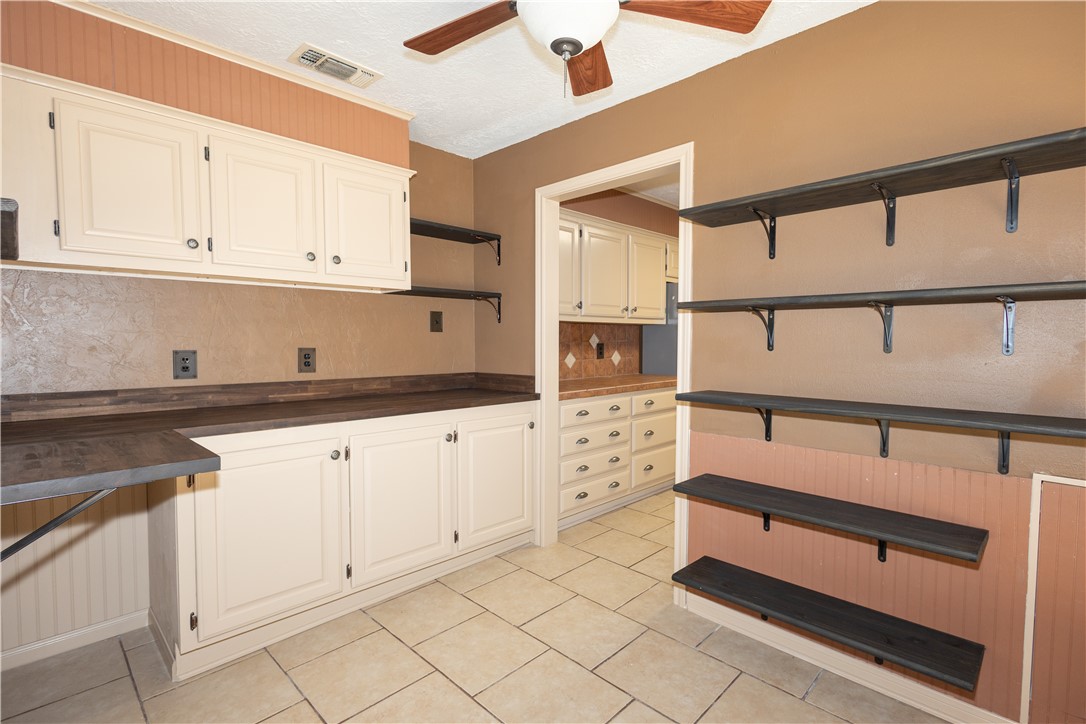 2903 Par Drive Bryan, TX 77802 - Photo 5 of 26 a kitchen with white cabinets and window
