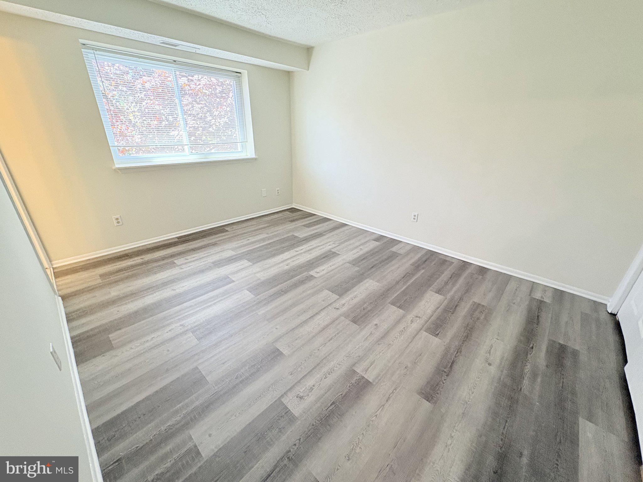 11905 I Tarragon Road, Unit I Reisterstown, MD 21136 - Photo 11 of 13 a view of a room with wooden floor and window