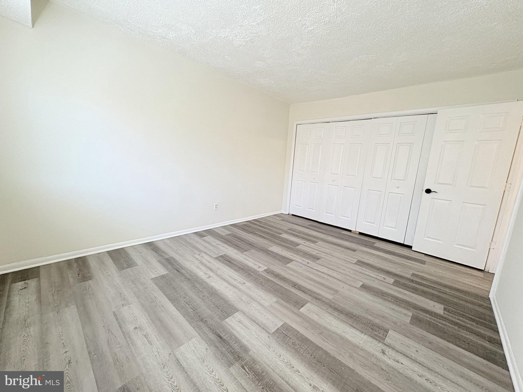 11905 I Tarragon Road, Unit I Reisterstown, MD 21136 - Photo 12 of 13 a view of empty room with wooden floor