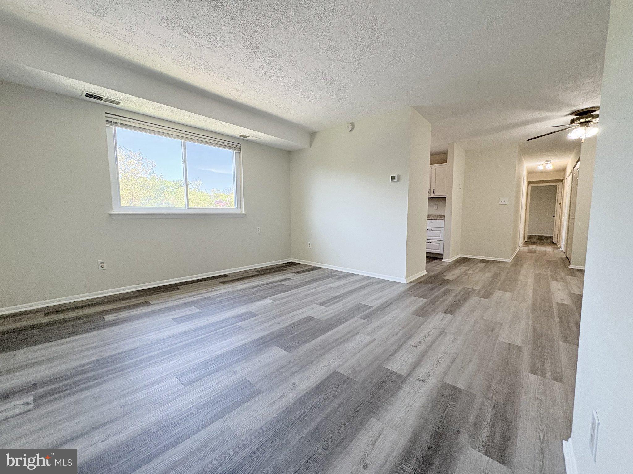 11905 I Tarragon Road, Unit I Reisterstown, MD 21136 - Photo 2 of 13 an empty room with wooden floor and a window