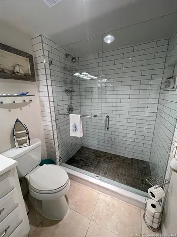 a bathroom with a toilet and shower