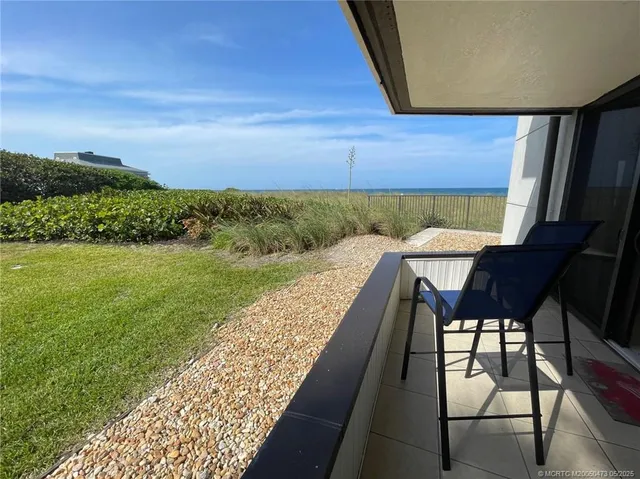 a view of a chairs and table in patio