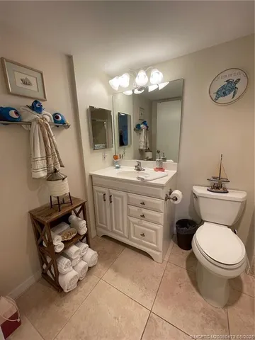 a bathroom with a sink mirror and toilet