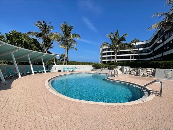 a view of outdoor space with swimming pool and furniture
