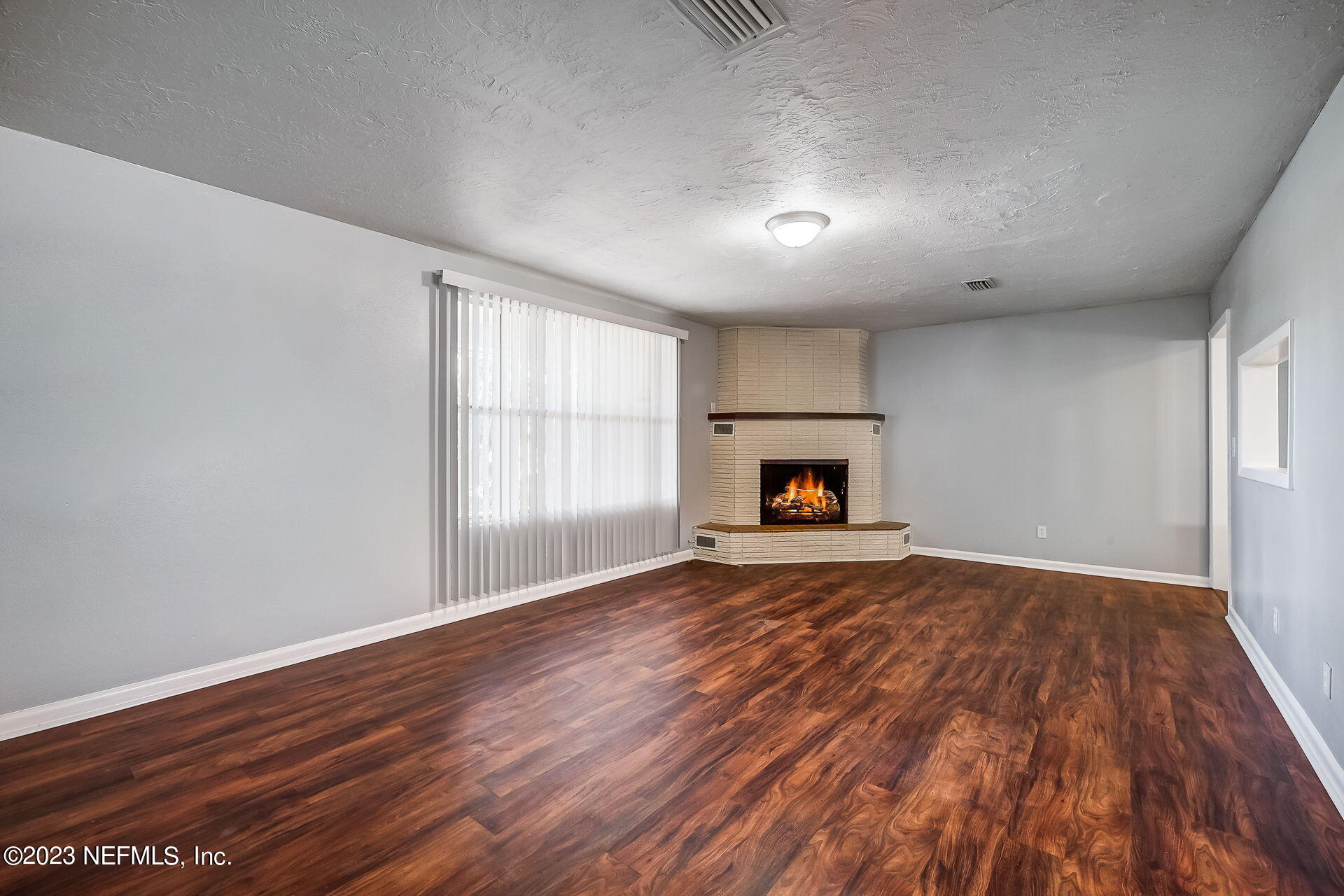 3546 Clyde Drive Jacksonville, FL 32208 - Photo 12 of 50 wooden floor in an empty room with a window