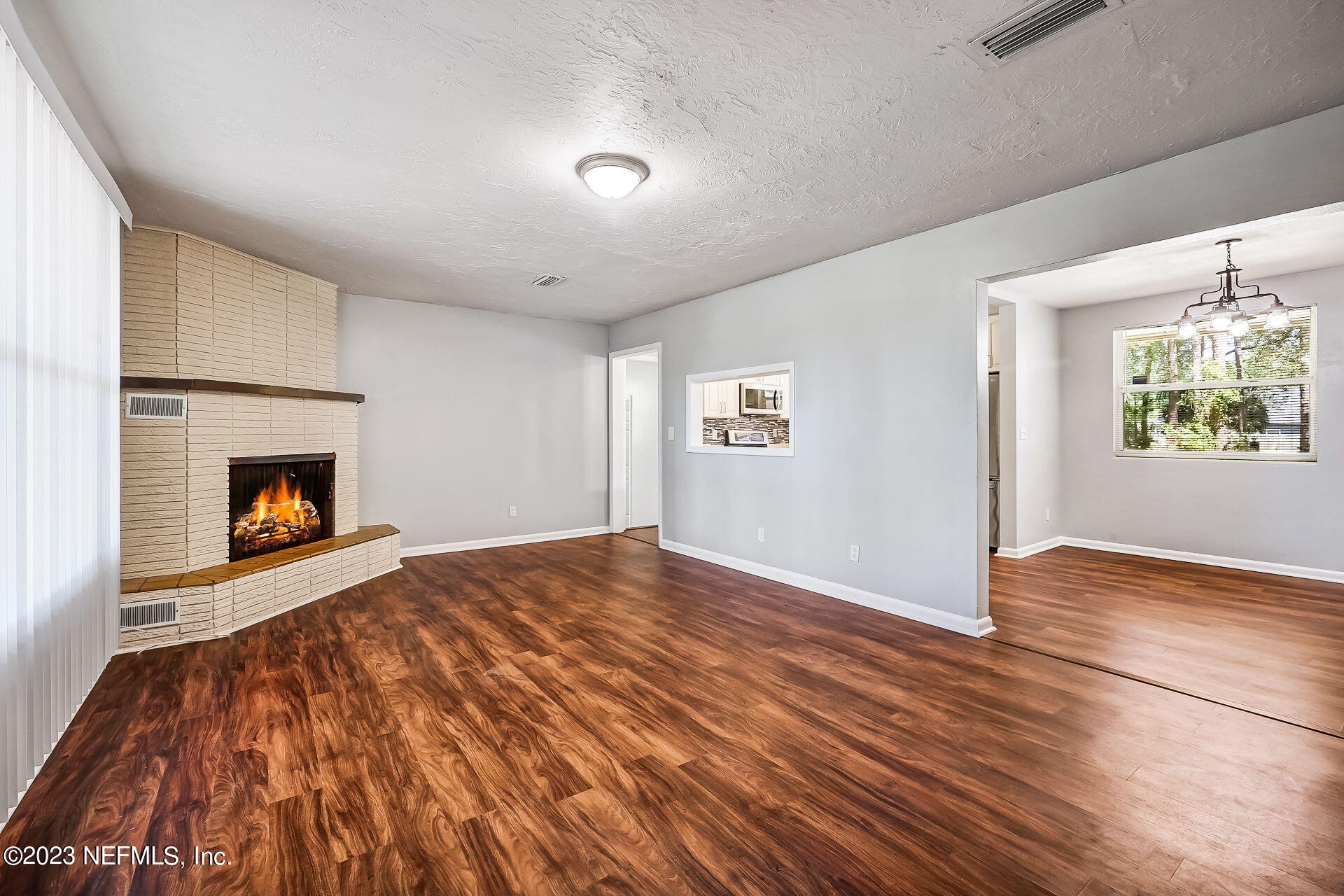3546 Clyde Drive Jacksonville, FL 32208 - Photo 13 of 50 a view of empty room with wooden floor and fireplace