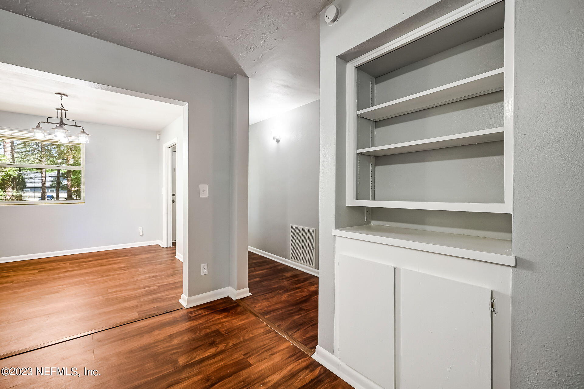 3546 Clyde Drive Jacksonville, FL 32208 - Photo 14 of 50 a view of an empty room with wooden floor and a window
