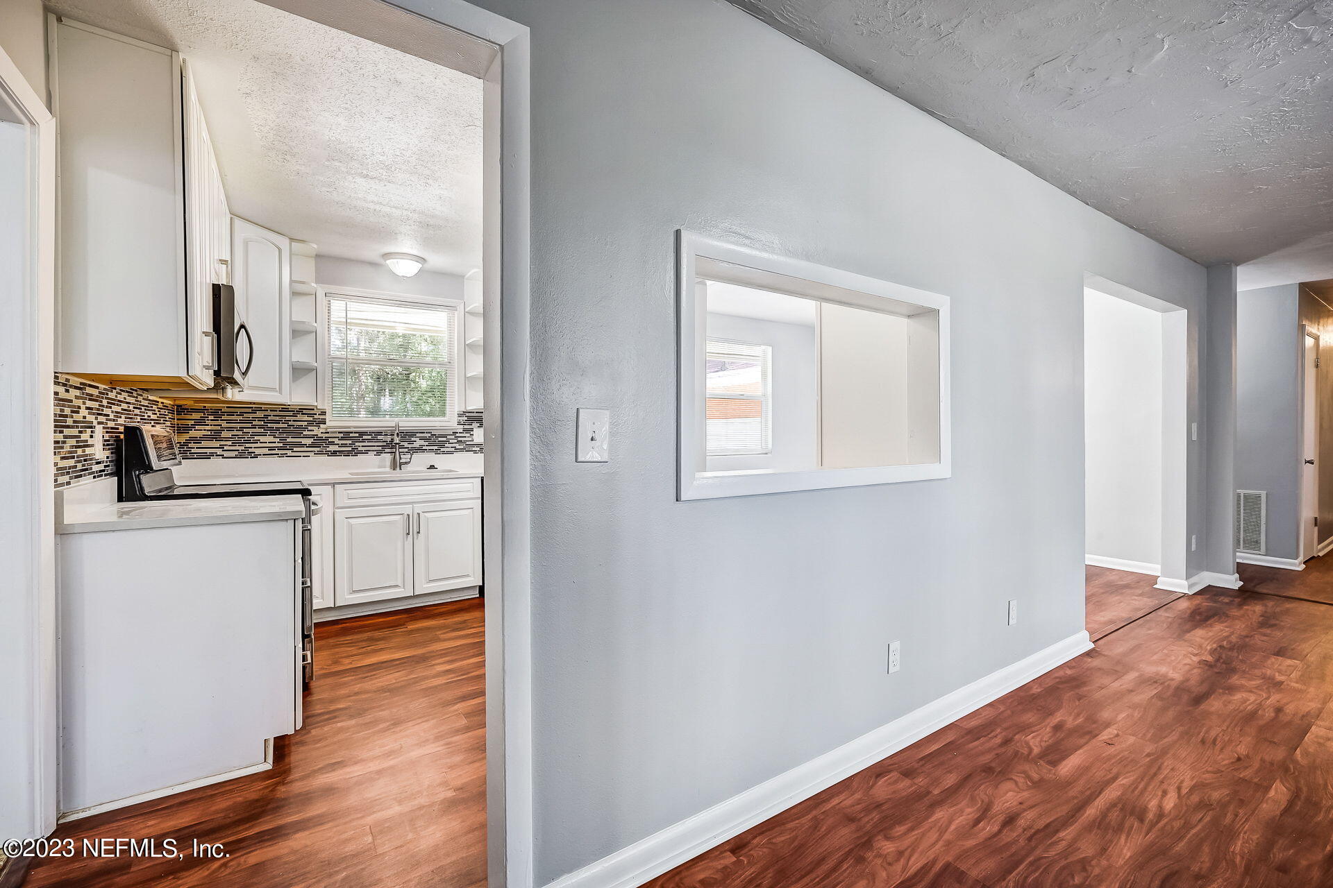 3546 Clyde Drive Jacksonville, FL 32208 - Photo 17 of 50 a view of a kitchen cabinets and wooden floor