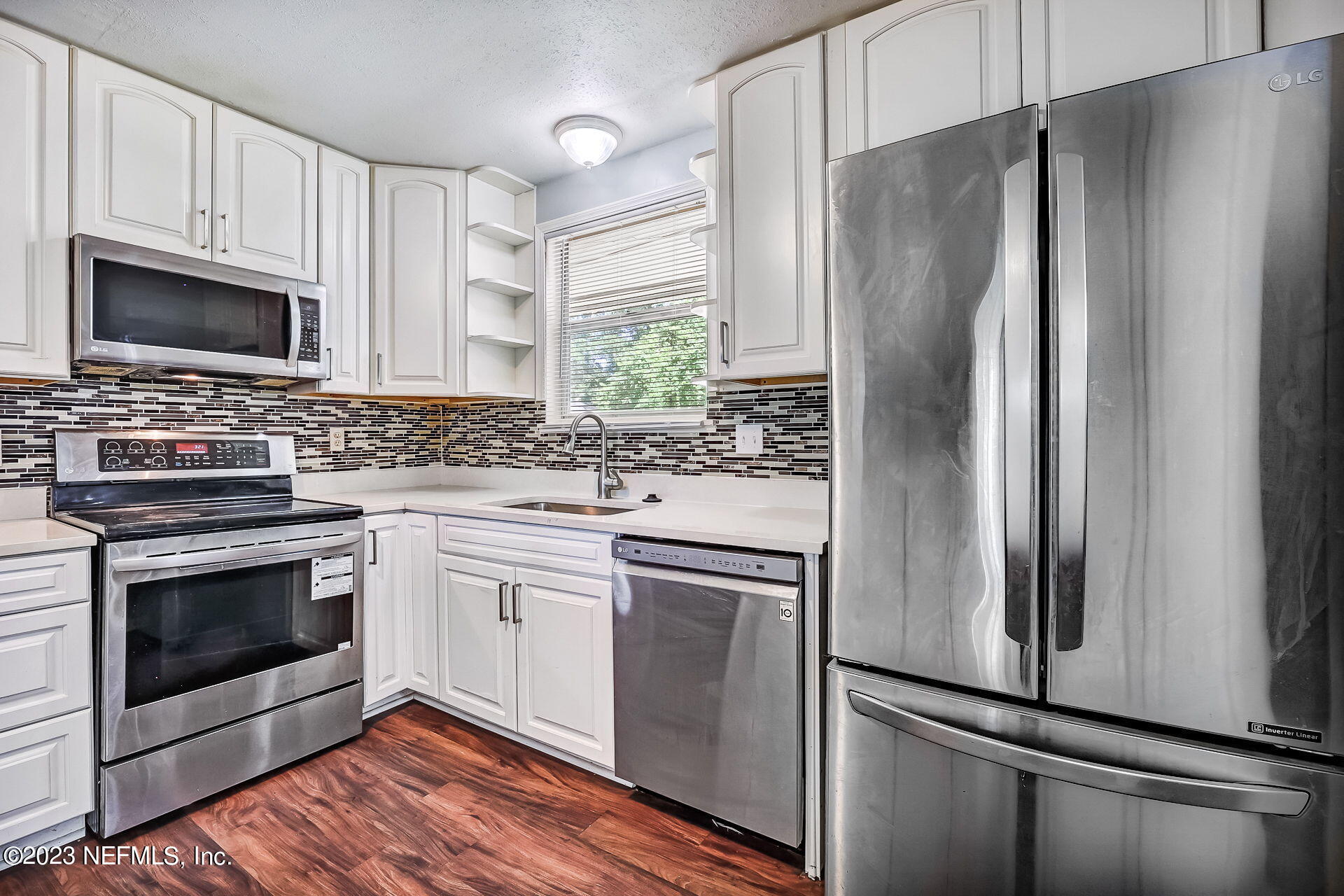 3546 Clyde Drive Jacksonville, FL 32208 - Photo 20 of 50 a kitchen with stainless steel appliances a refrigerator sink and microwave
