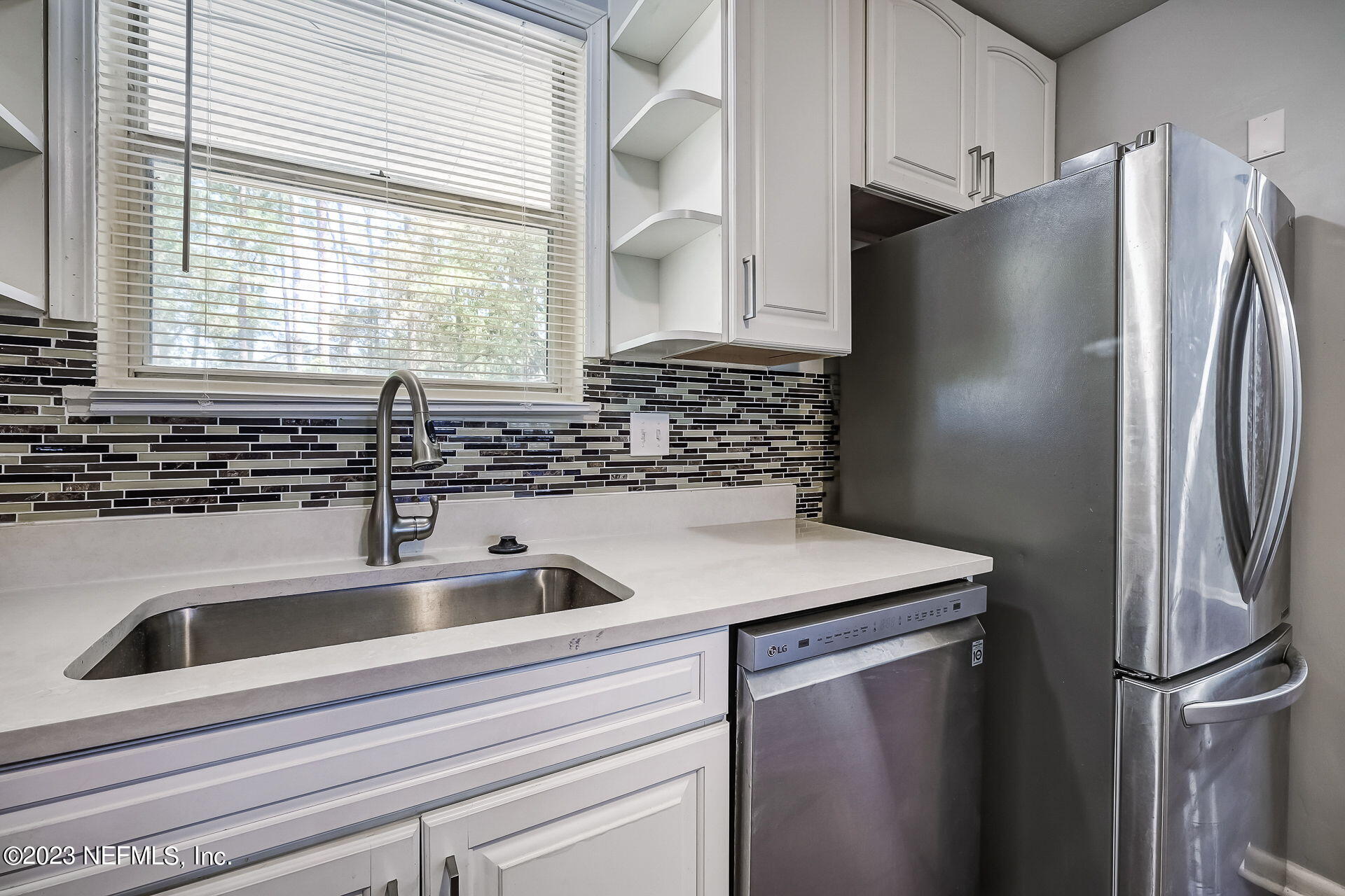3546 Clyde Drive Jacksonville, FL 32208 - Photo 22 of 50 a kitchen with stainless steel appliances granite countertop a refrigerator and a sink