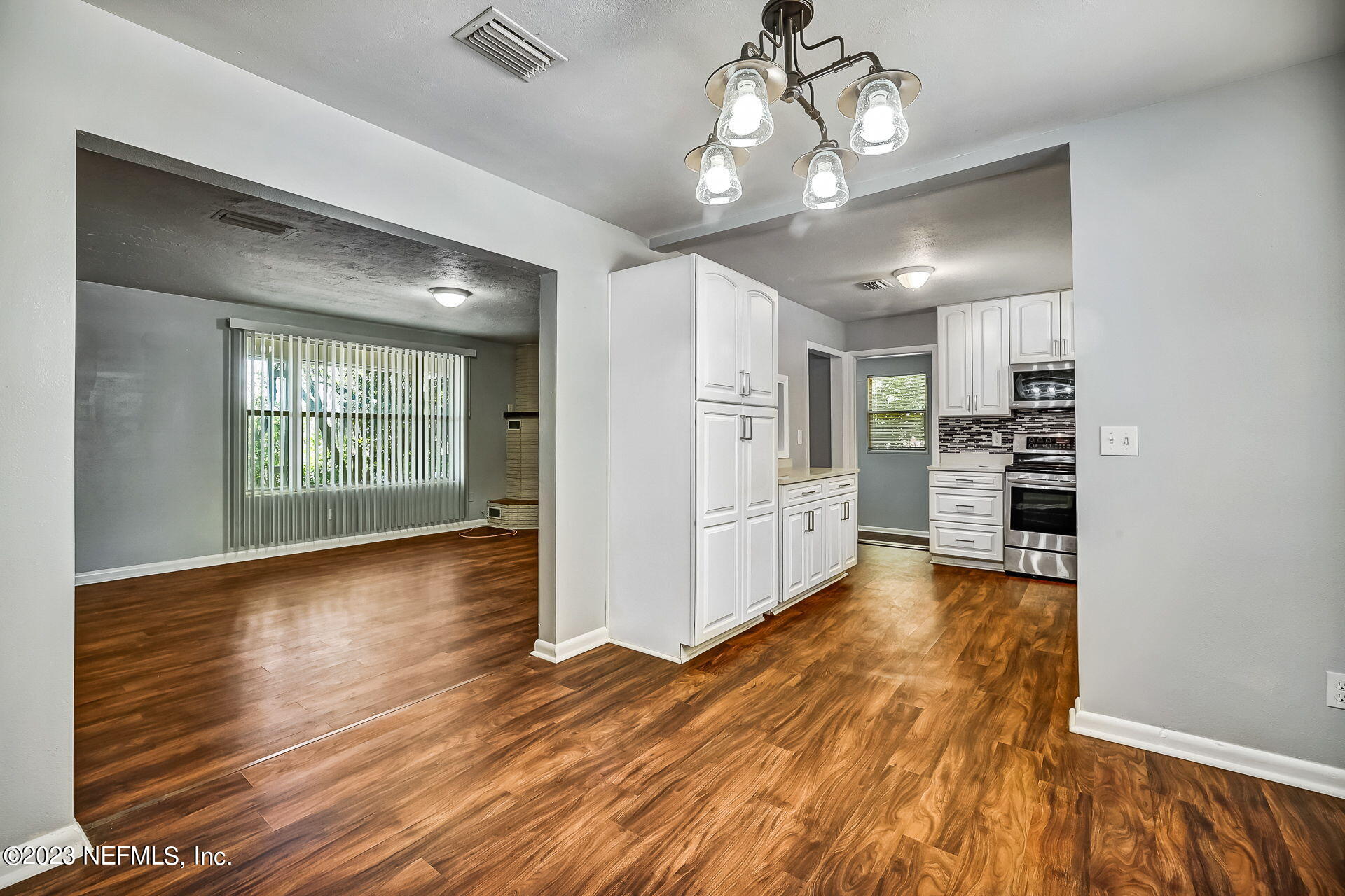 3546 Clyde Drive Jacksonville, FL 32208 - Photo 25 of 50 a view of a kitchen with a stove cabinets and wooden floor