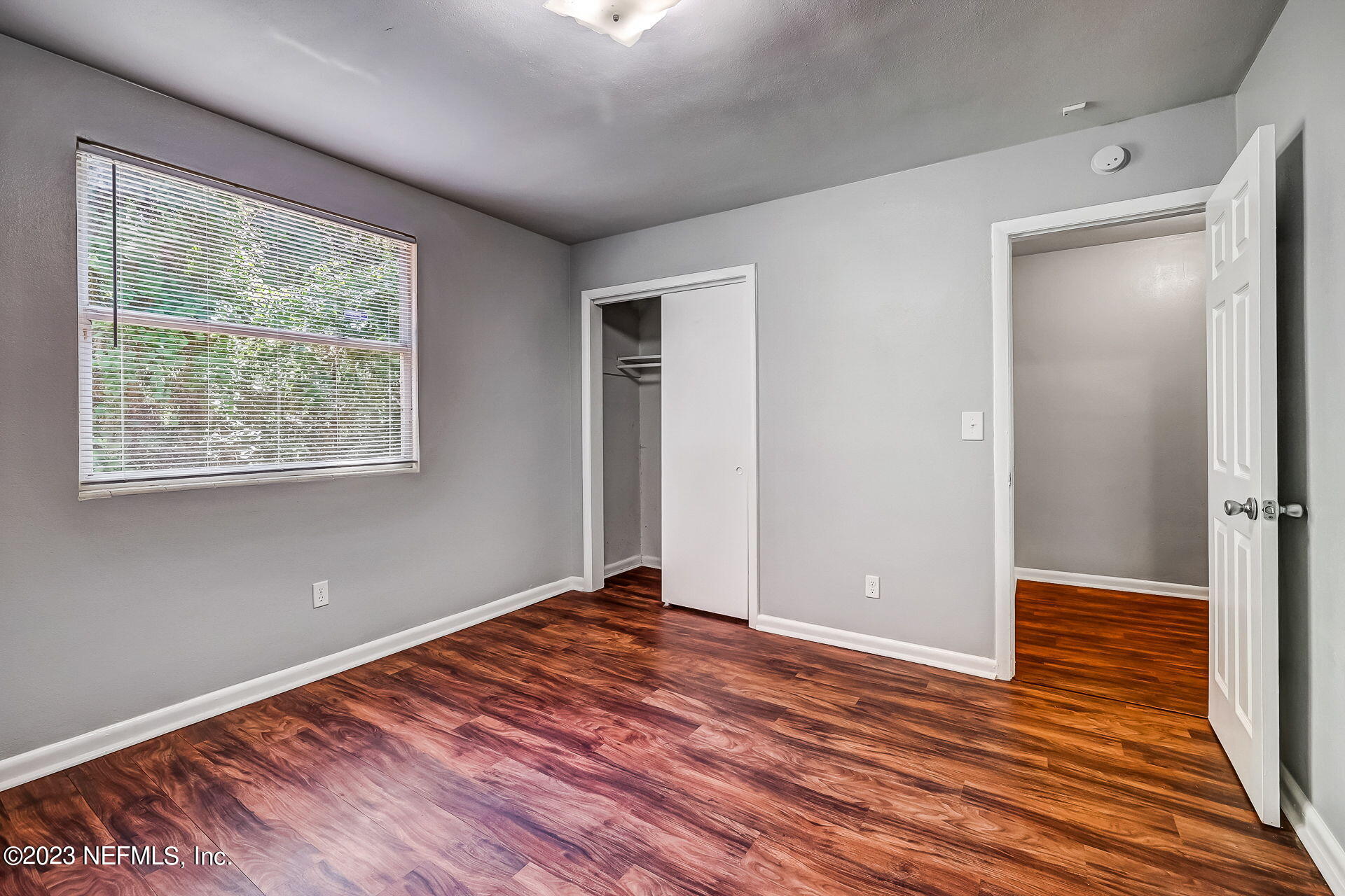 3546 Clyde Drive Jacksonville, FL 32208 - Photo 36 of 50 a view of an empty room with wooden floor and a window