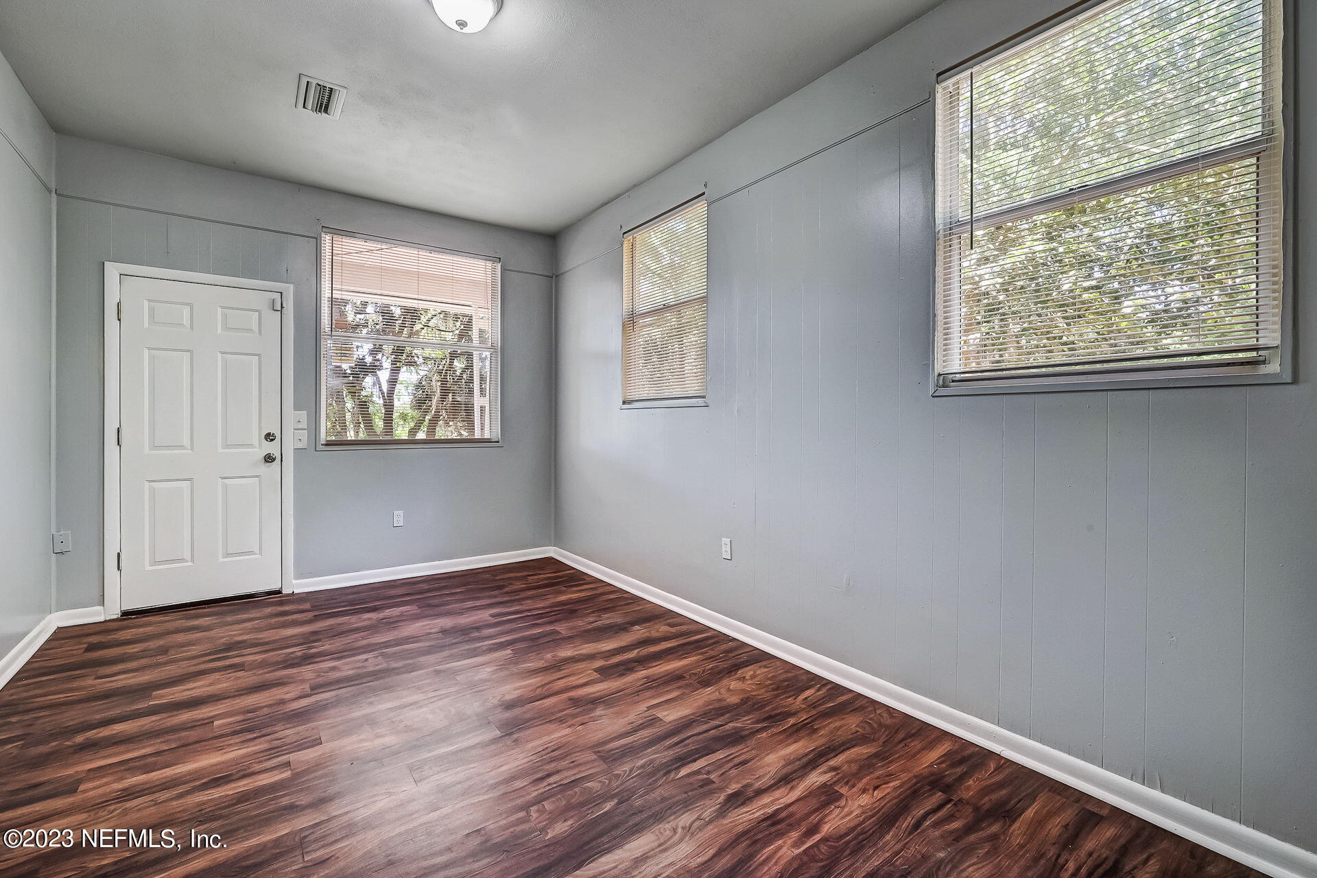 3546 Clyde Drive Jacksonville, FL 32208 - Photo 38 of 50 an empty room with wooden floor and windows