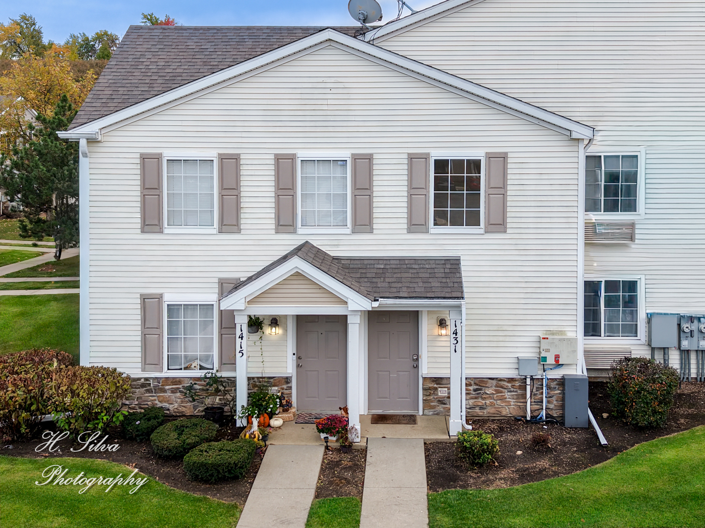 1431 Silverstone Drive, Unit 1431 Carpentersville, IL 60110 - Photo 18 of 18 a front view of a house with a yard and porch