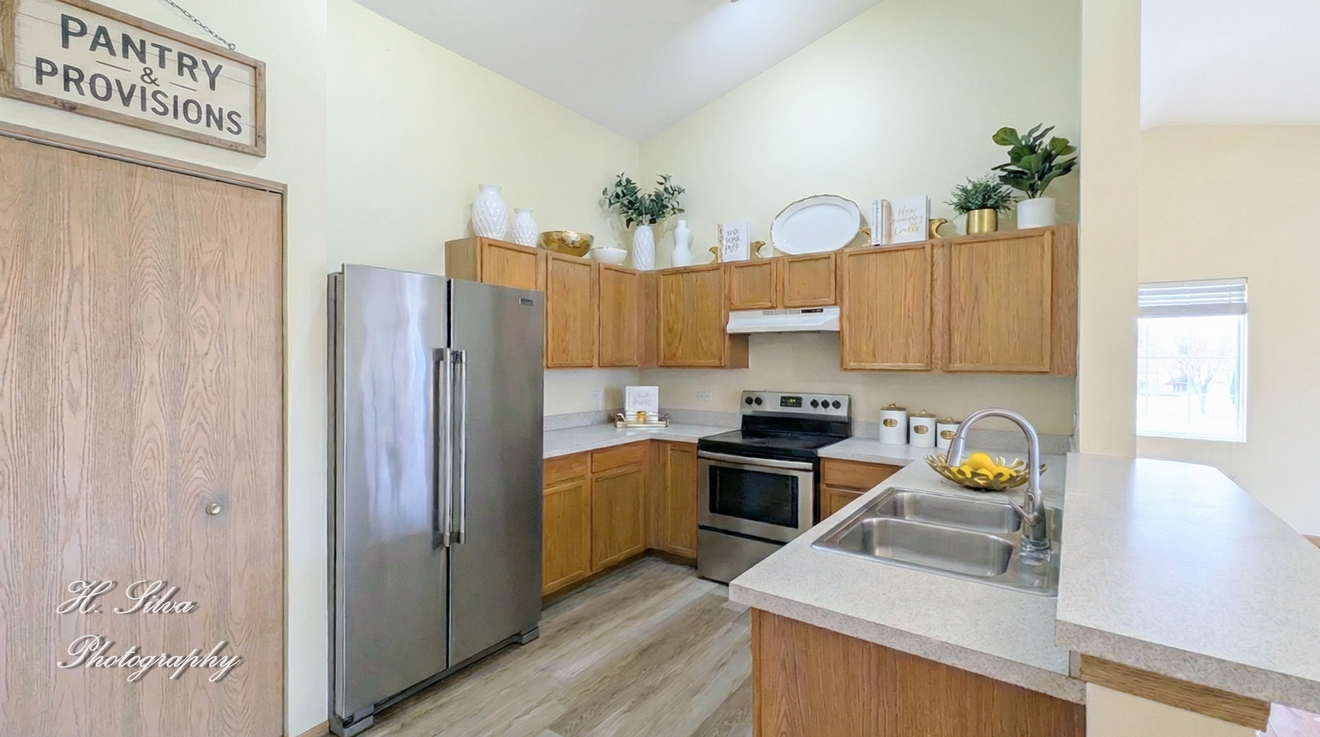 1431 Silverstone Drive, Unit 1431 Carpentersville, IL 60110 - Photo 5 of 18 a kitchen with stainless steel appliances granite countertop a refrigerator a sink dishwasher and white cabinets with wooden floor