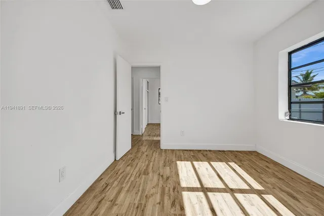 a view of a room with wooden floor and small space