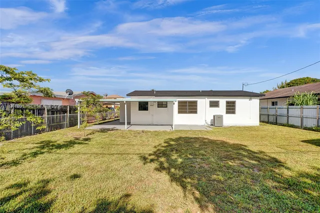 a house view with swimming pool in front of it