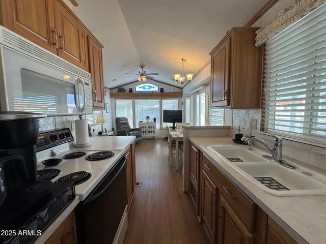 a kitchen with stainless steel appliances granite countertop a sink stove and cabinets