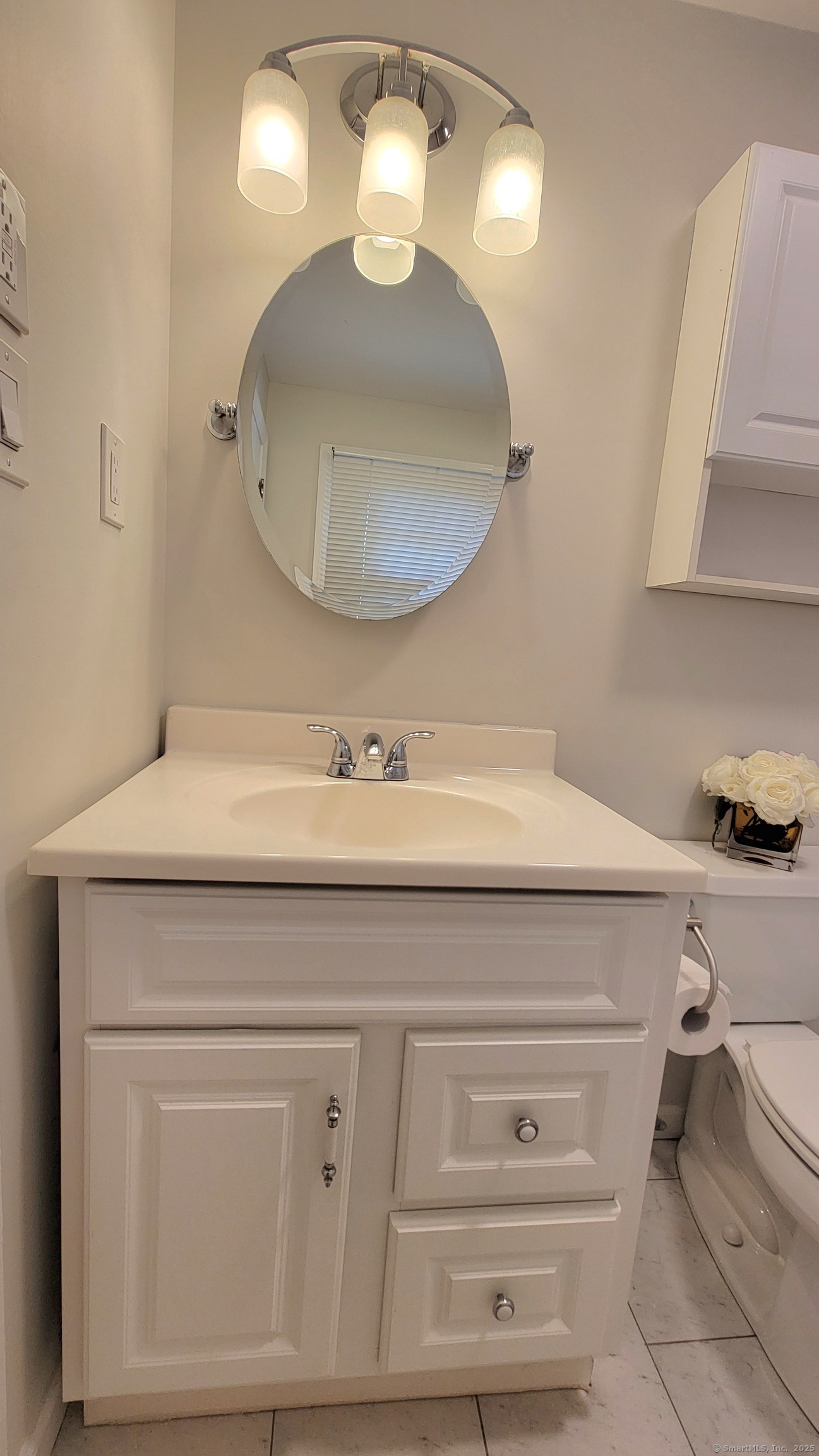 12 Brewster Road, Unit 12B Glastonbury, CT 06033 - Photo 16 of 19 a bathroom with a sink mirror and vanity