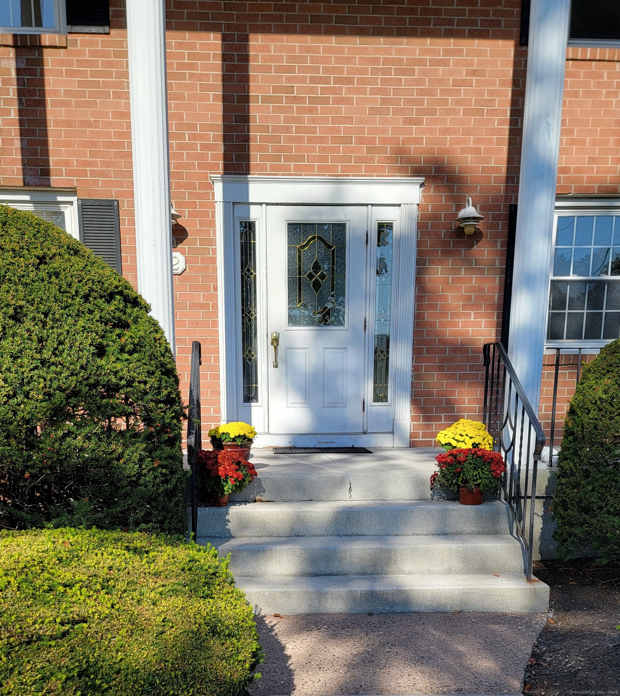 12 Brewster Road, Unit 12B Glastonbury, CT 06033 - Photo 3 of 19 a front view of a house with outdoor seating