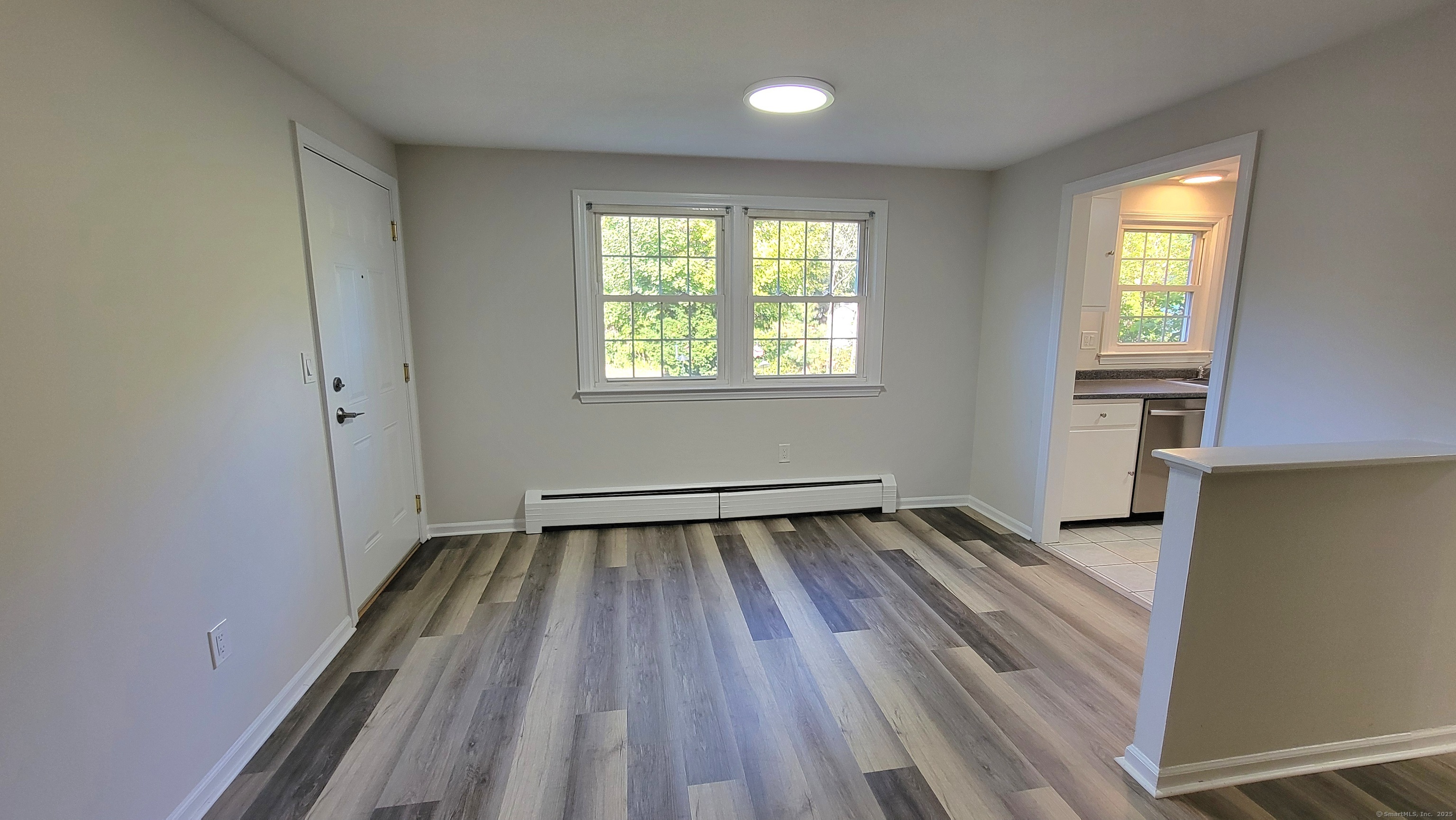 12 Brewster Road, Unit 12B Glastonbury, CT 06033 - Photo 9 of 19 wooden floor in an empty room with a window