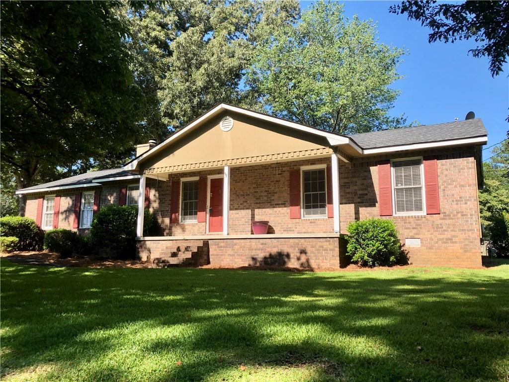 a front view of house with yard and green space