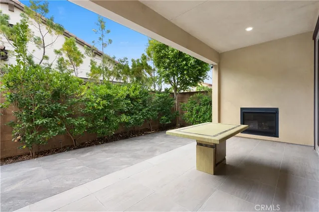 a view of a patio with chairs and a potted plant
