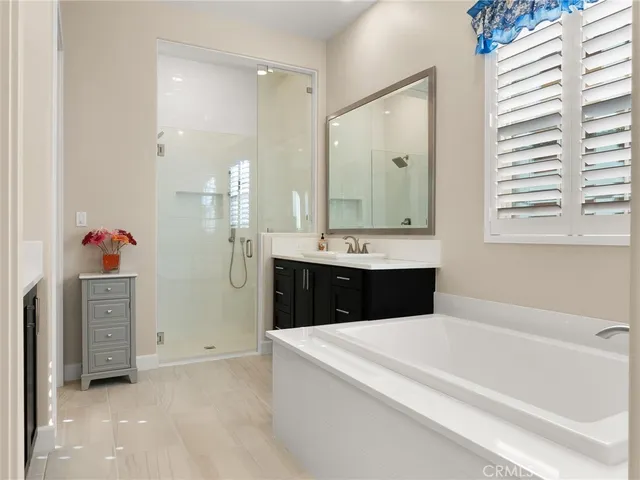 a bathroom with a tub sink and mirror