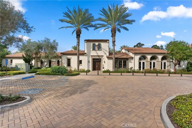 a front view of a house with a garden and yard