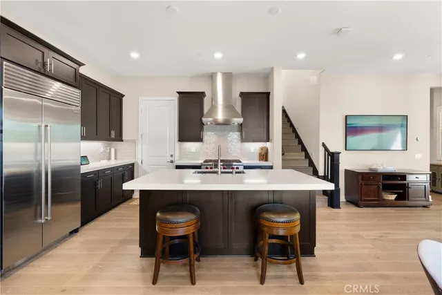 a kitchen with a sink stainless steel appliances and cabinets