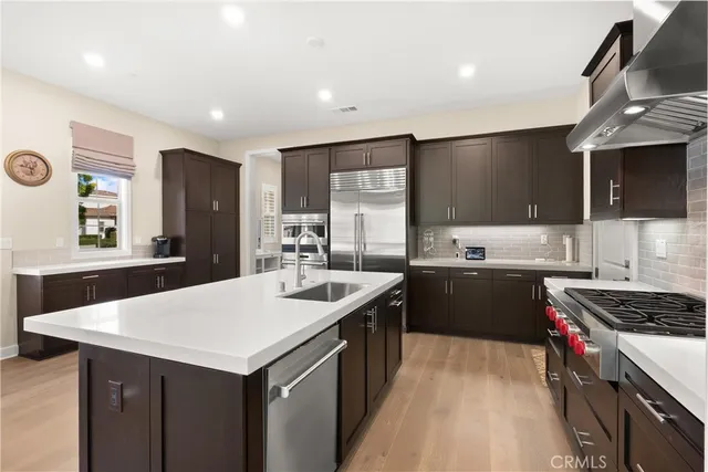a kitchen that has a sink and a stove in it