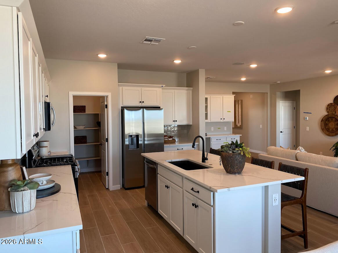 17547 West Fulton Street Goodyear, AZ 85338 - Photo 1 of 10 a kitchen with a refrigerator a sink and a stove