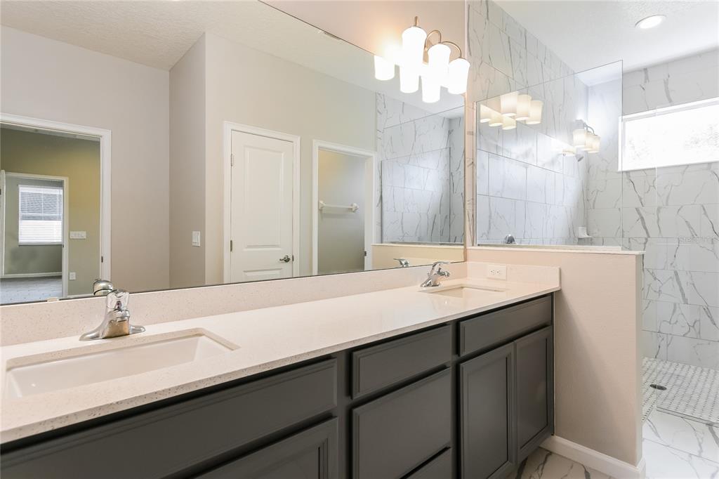 1073 Hendon Loop Davenport, FL 33837 - Photo 11 of 15 a bathroom with double vanity sinks and a mirror