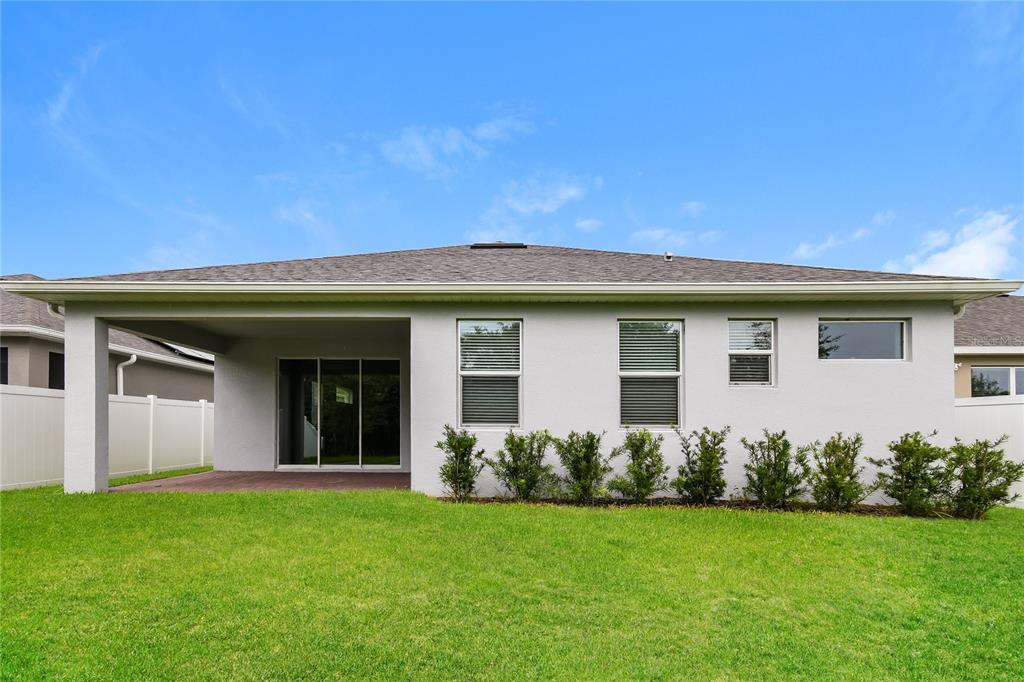 1073 Hendon Loop Davenport, FL 33837 - Photo 15 of 15 a front view of a house with a garden