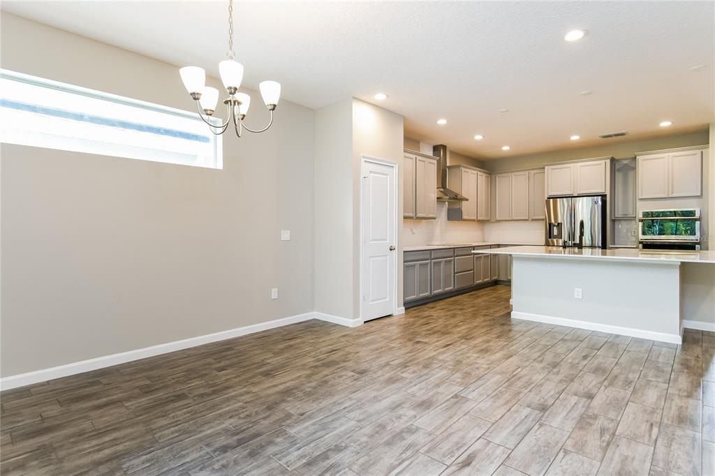 1073 Hendon Loop Davenport, FL 33837 - Photo 6 of 15 a view of kitchen with granite countertop cabinets and refrigerator
