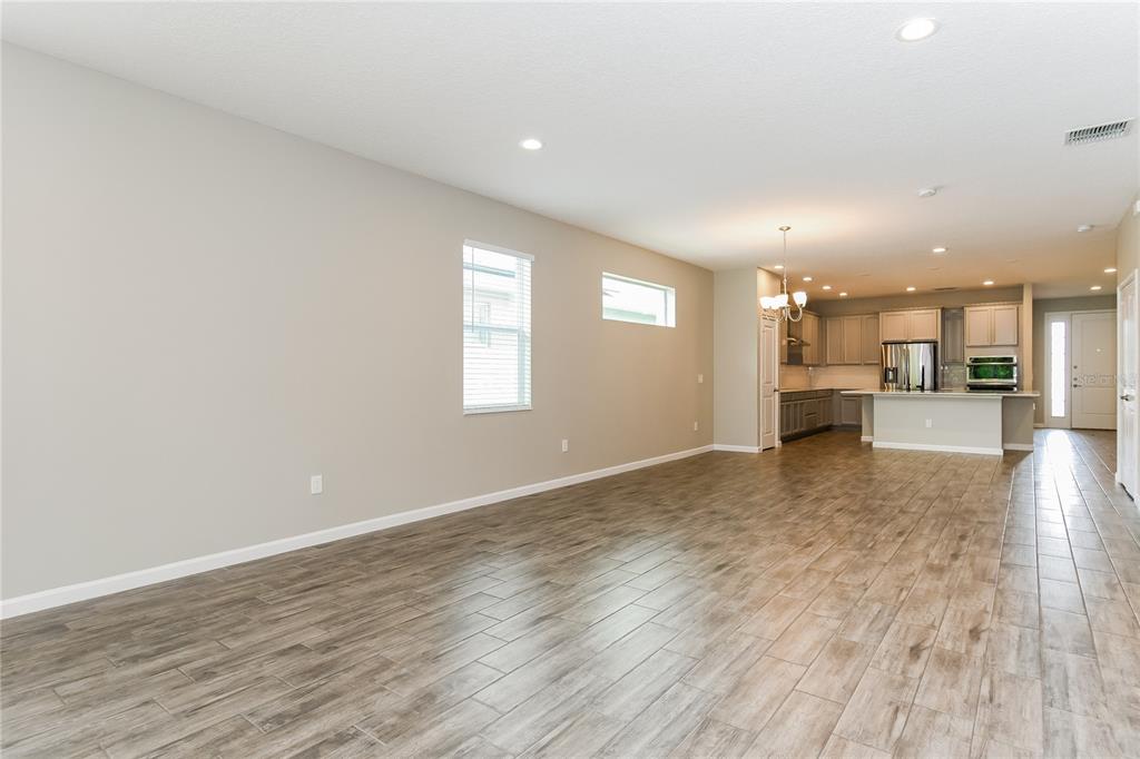 1073 Hendon Loop Davenport, FL 33837 - Photo 8 of 15 an empty room with wooden floor and windows