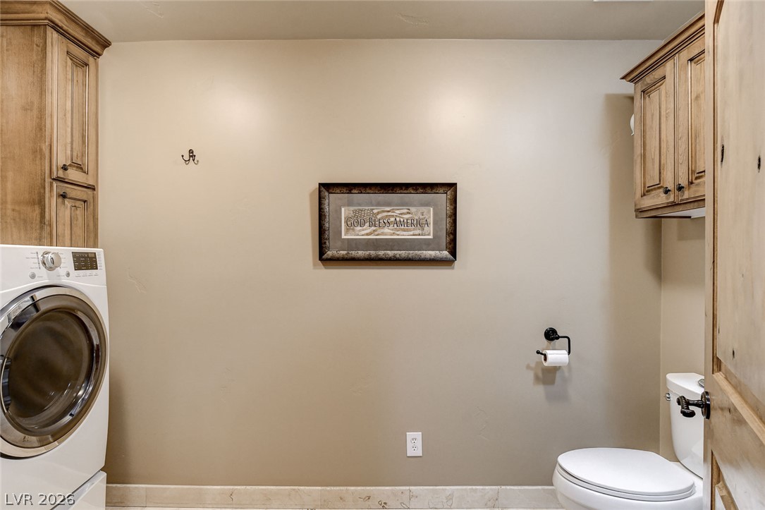 1950 Bowman Road Logandale, NV 89021 - Photo 46 of 81 Functional laundry space featuring durable tile flooring and natural wood cabinetry.