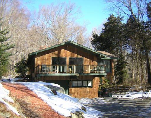 43 Cedar Road Wilton, CT 06897 - Photo 1 of 1 a view of a house with a yard covered in snow