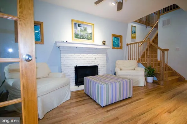 a living room with furniture wooden floor and a fireplace
