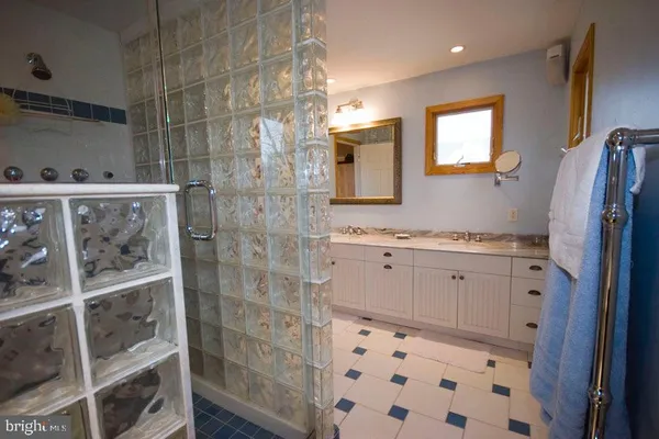 a bathroom with a shower and a sink