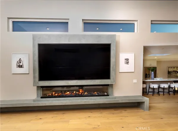 a living room with a fireplace and flat screen tv