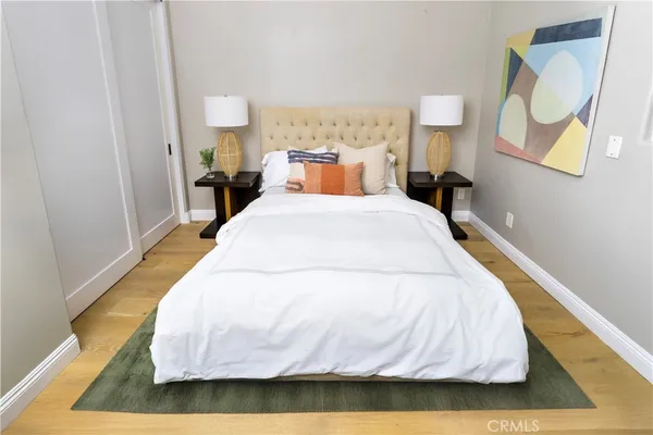 a bed room with a bed and a night stand