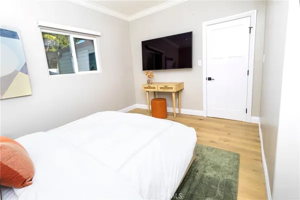 a bedroom with a bed and a flat screen tv