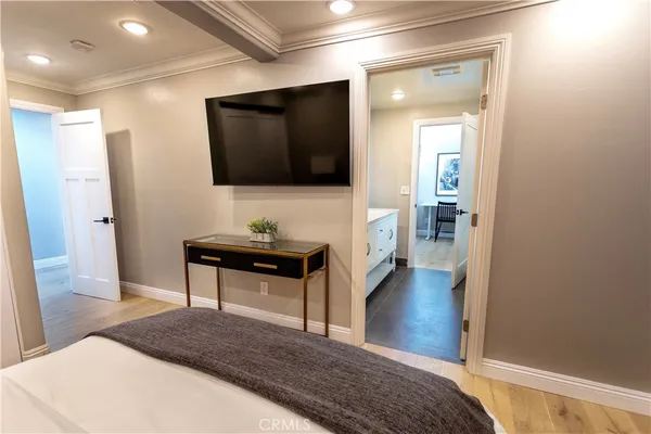 a living room with a bed and a flat screen tv