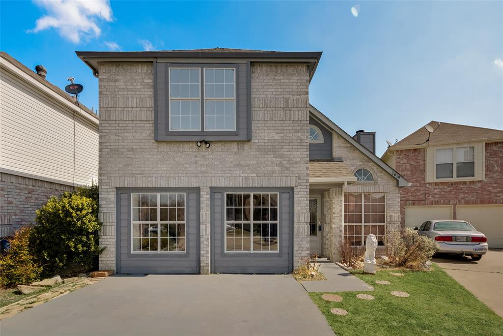 a front view of a house with a yard and porch