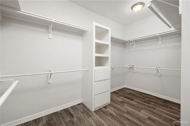 a view of walk in closet with empty racks