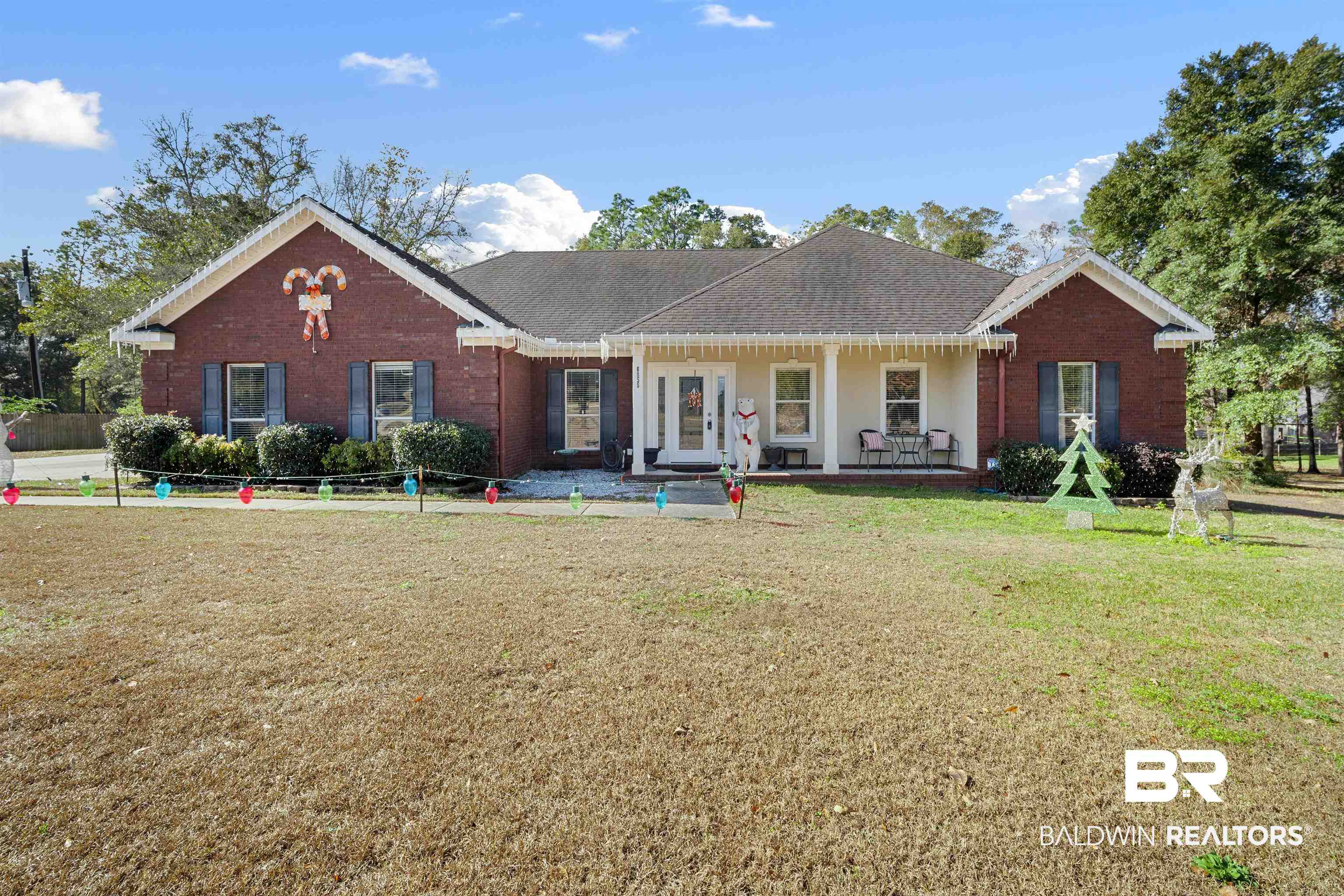 6855 Kali Oka Road Saraland, AL 36571 - Photo 1 of 1 Ranch-style home with a porch, brick siding, and a front lawn