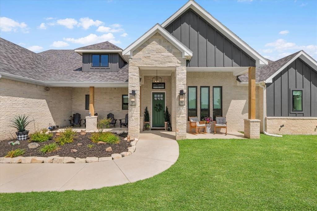 1059 Sweeney Way Weatherford, TX 76087 - Photo 32 of 37 Contemporary exterior featuring light-colored stone, decorative exterior lighting and wood beams.