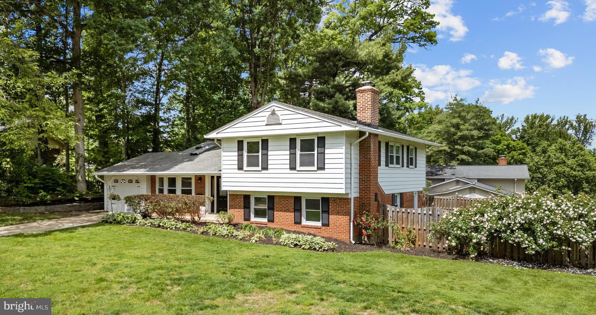 6800 Seton Court Springfield, VA 22152 - Photo 48 of 51 a front view of a house with a yard table and chairs